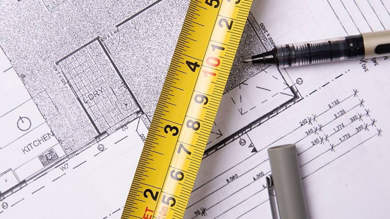 Measuring tape on a house plan