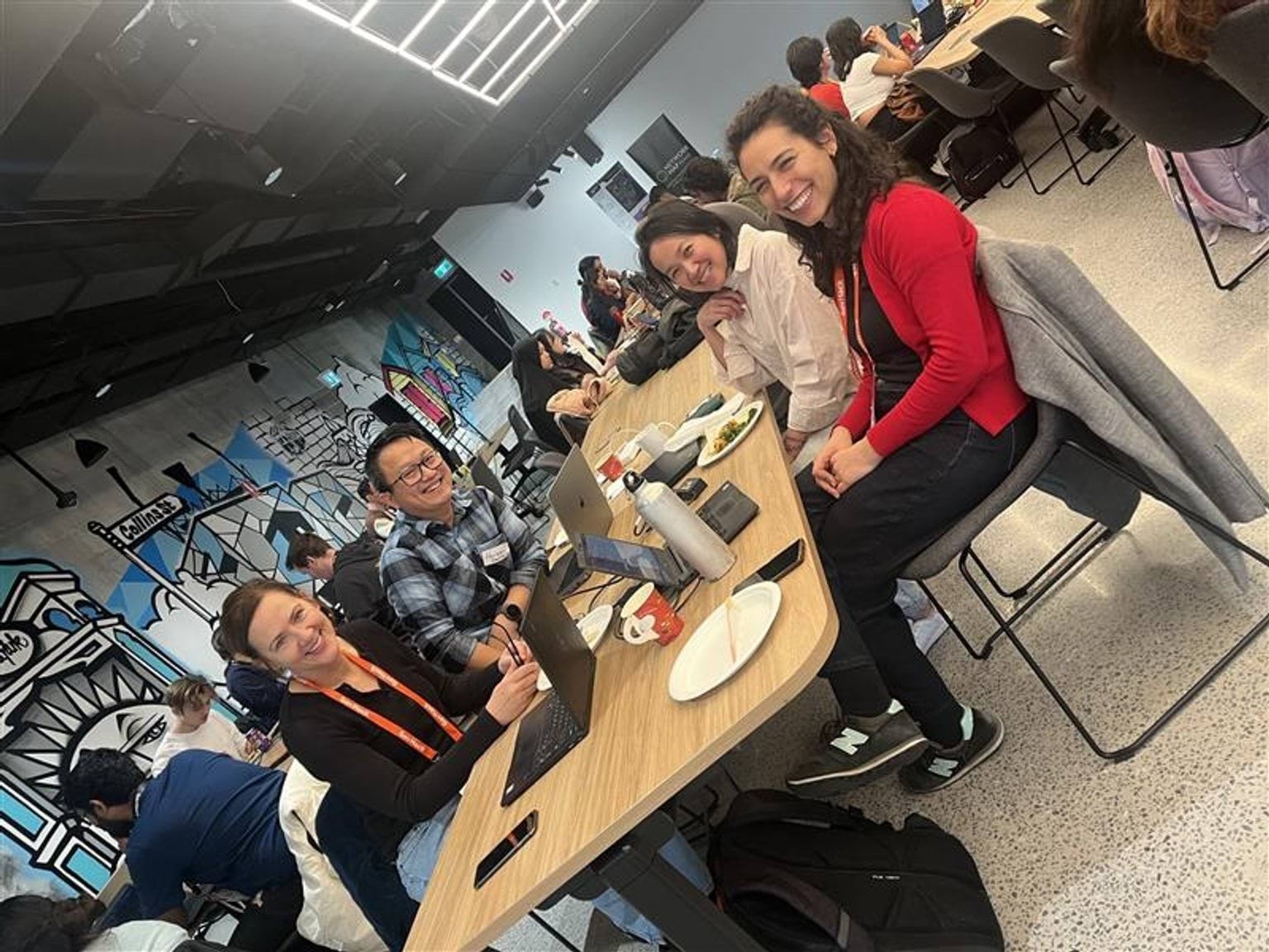 picture of people sitting at a desk smiling