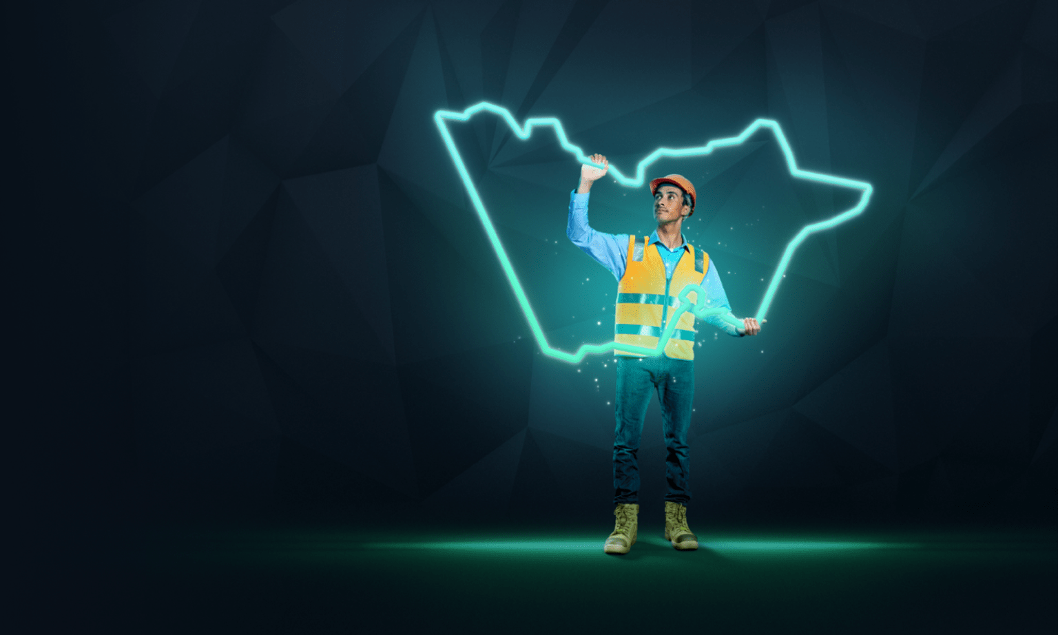 A construction worker holds up a glowing outline of the State of Victoria.