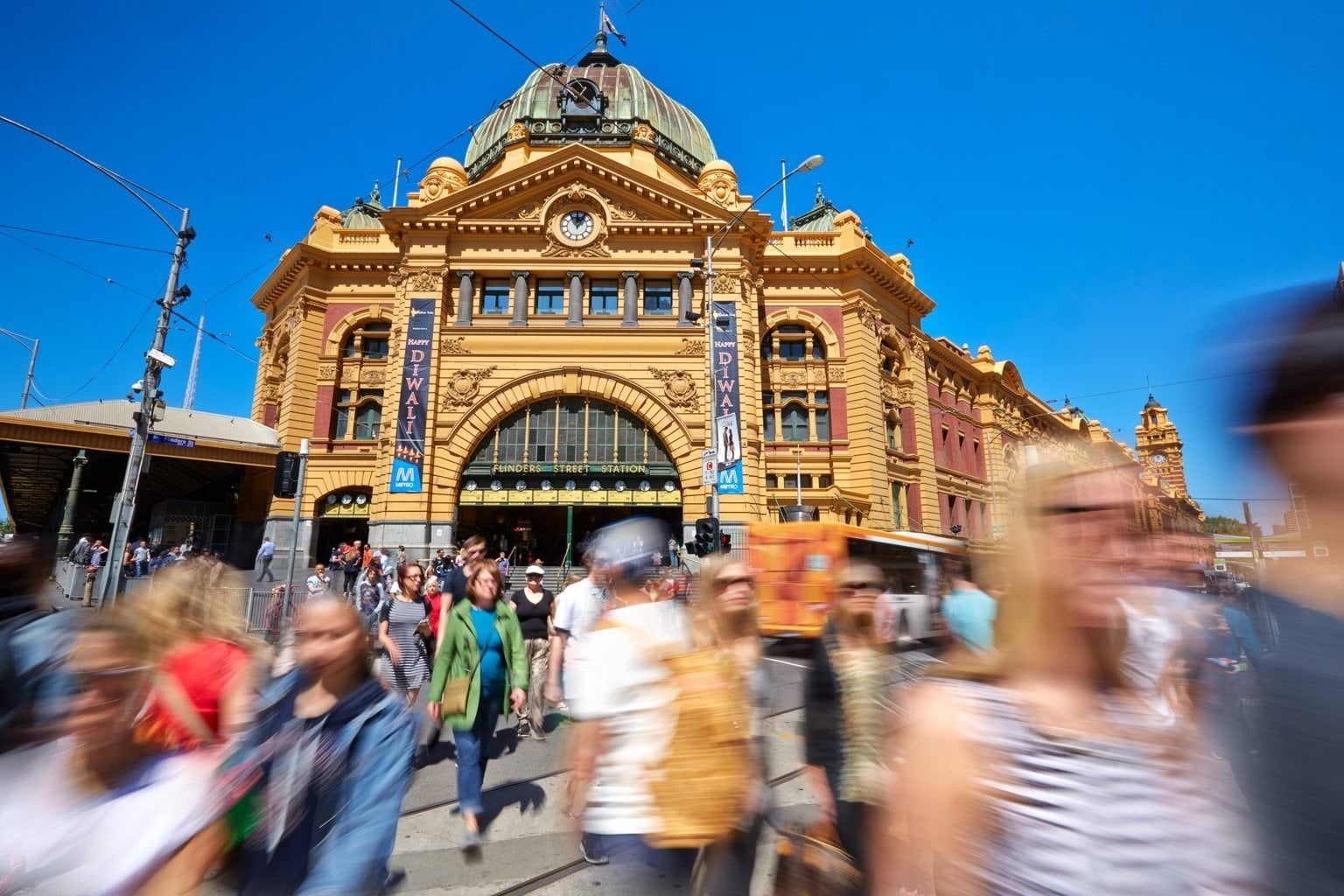 Photo of Flinders Street Station with people moving in the foreground