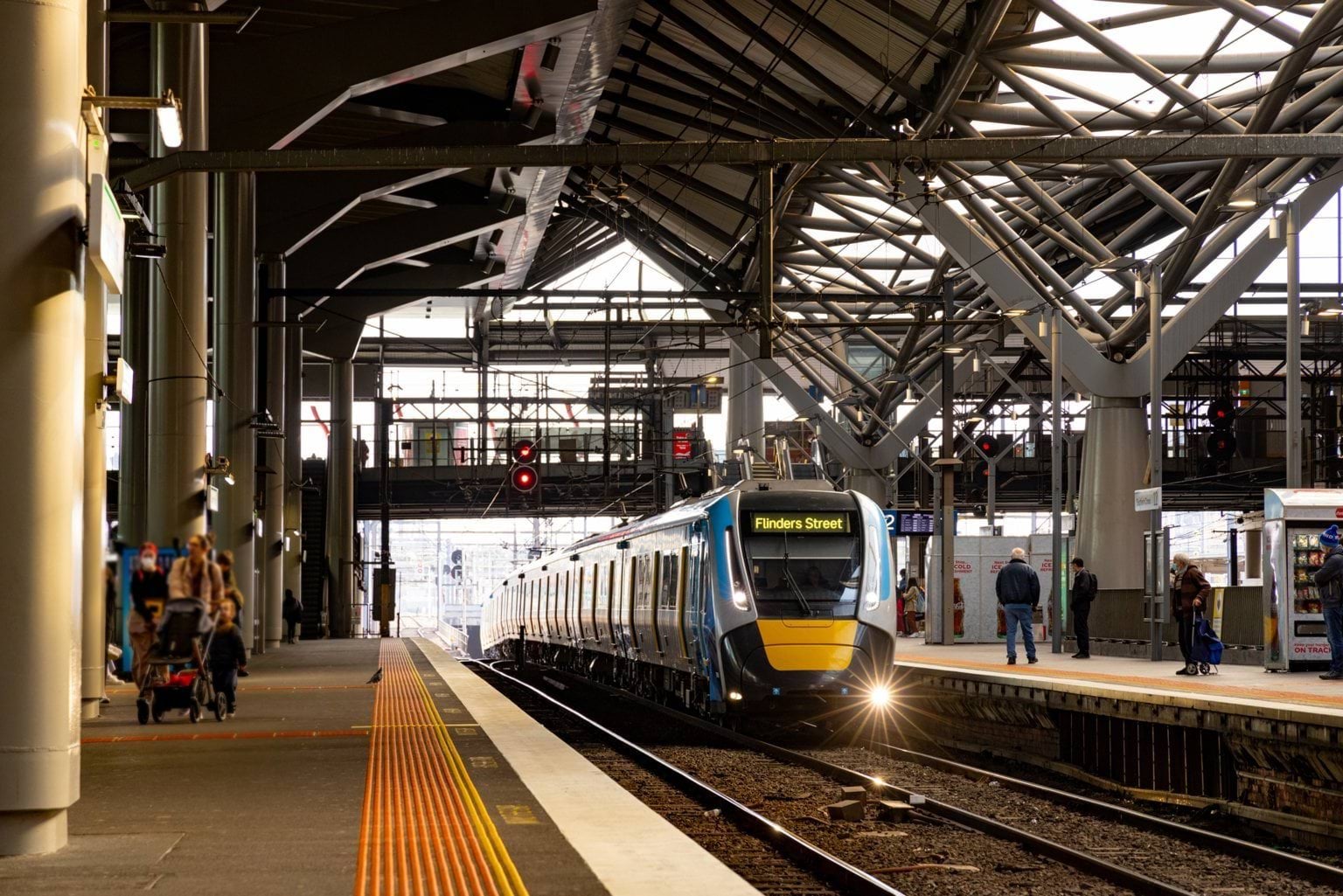 Train pulling into a platform at Southern Cross station