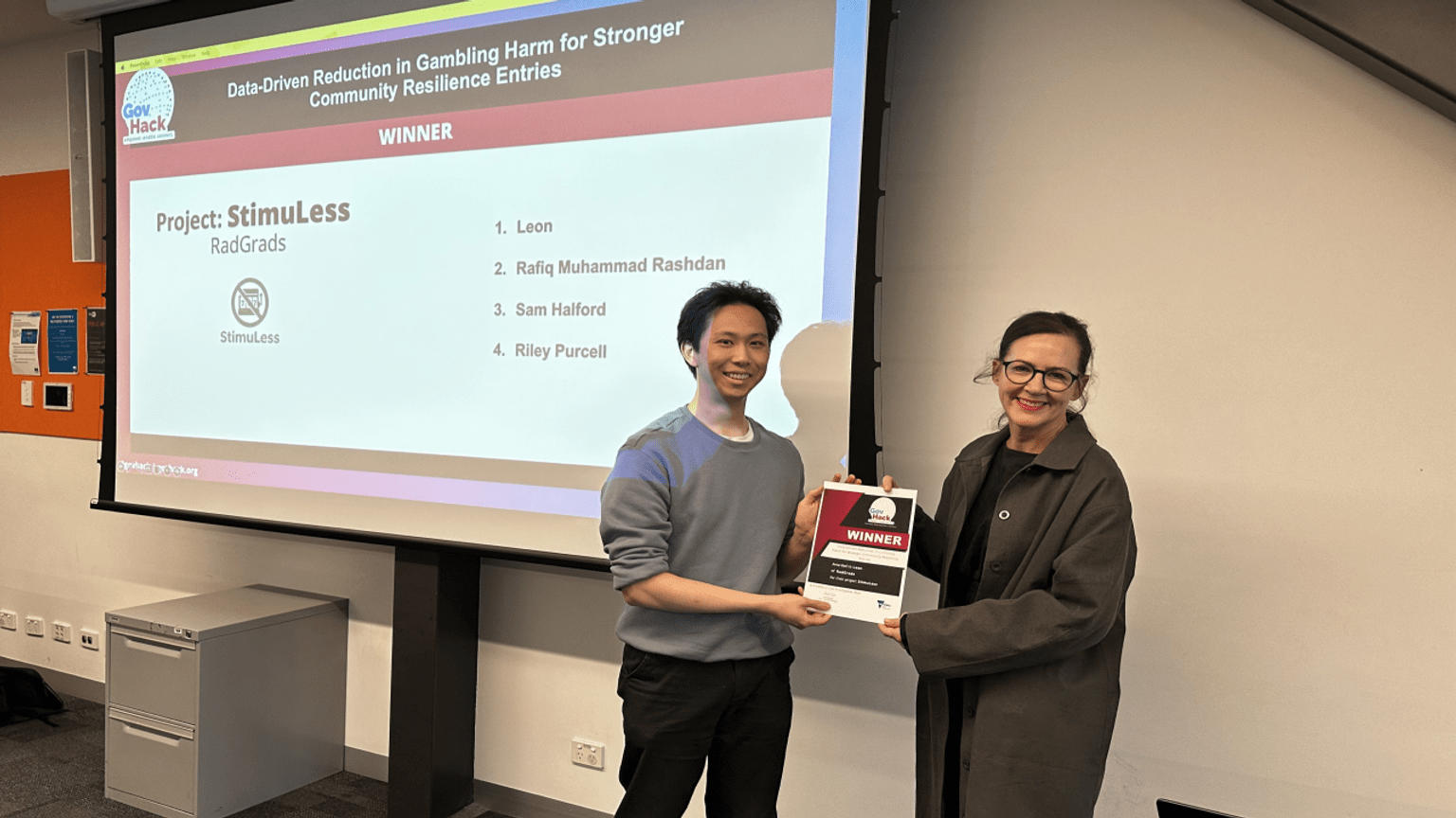 Image of GovHack winner being presented with a certificate